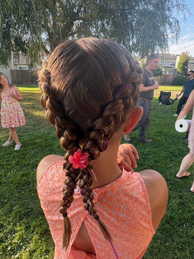 Braided updo with flower accent